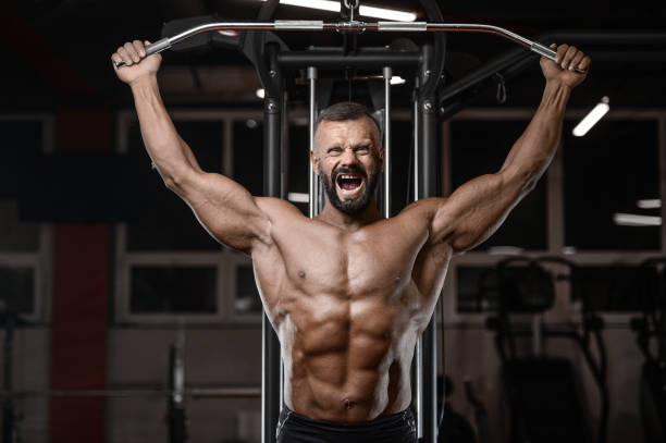 istock Old brutal strong bodybuilder athletic men pumping up muscles with dumbbells 902175440