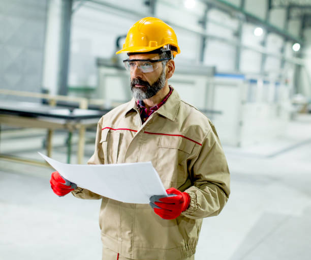 istock Senior supervisor looking at projest in the factory 902187188