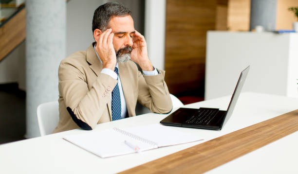 istock Senior businessman working on laptop computer in office 902187208