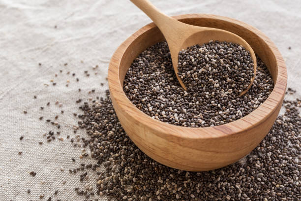 istock Chia seeds in wooden bowl background 902192192