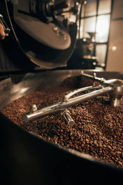 istock close up view of coffee beans roasting in machine 902195282