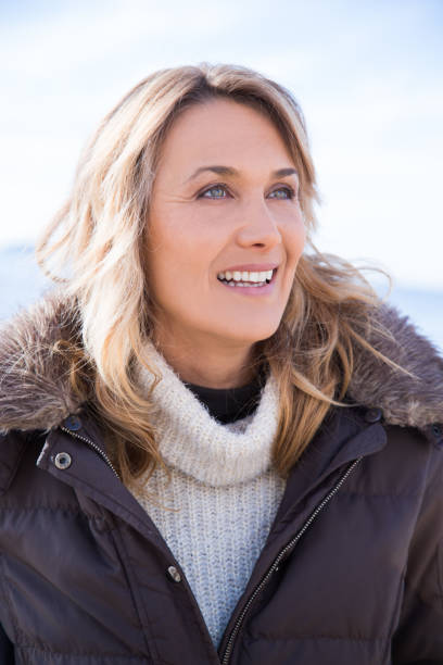 istock smiling woman in winter 902195546