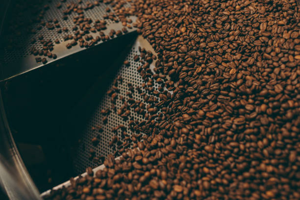 istock close up view of coffee beans roasting in machine 902196254