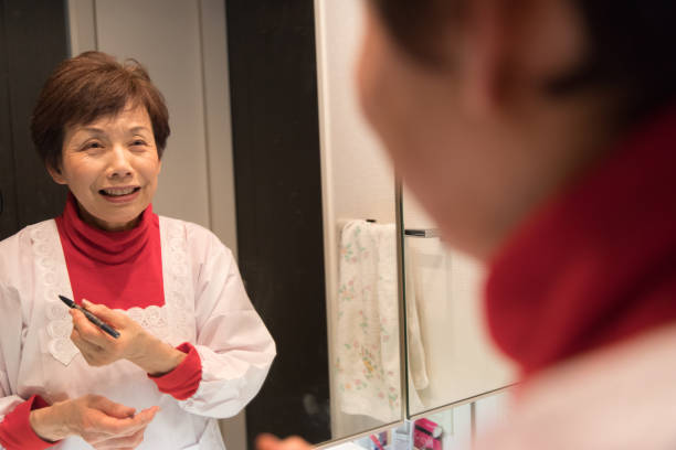 istock Japanese senior woman putting make up 902199214