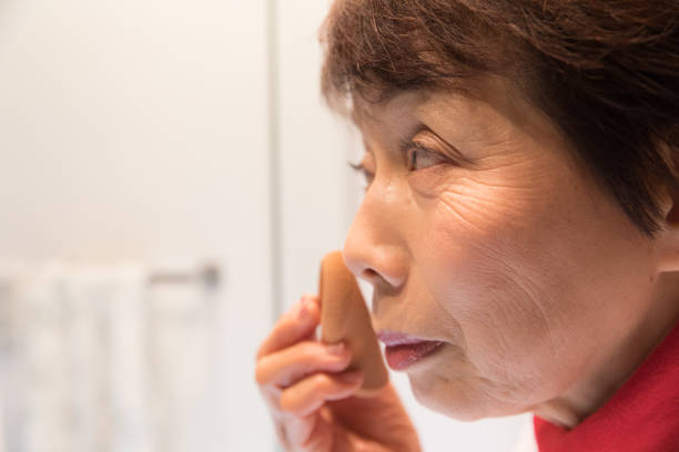 istock Japanese senior woman putting make up 902199286