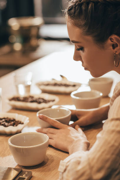 istock woman testing coffee beans in coffee shop 902199346