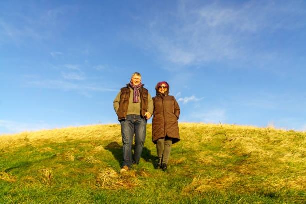 istock Senior couple walking on countryside path in winter 902199662
