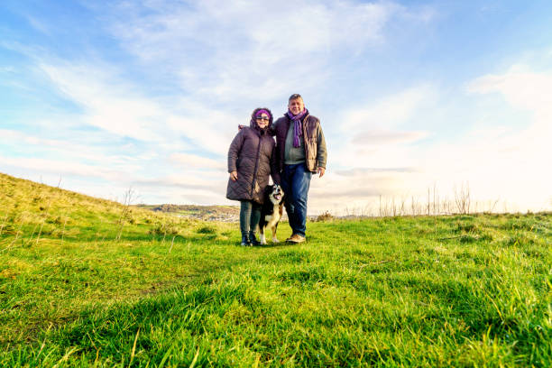 istock Senior couple walking on countryside path in winter 902199704