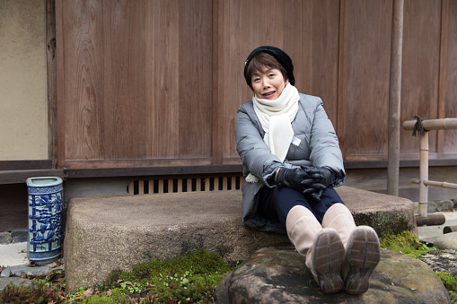 Japanese woman sitting in a Japanese garden