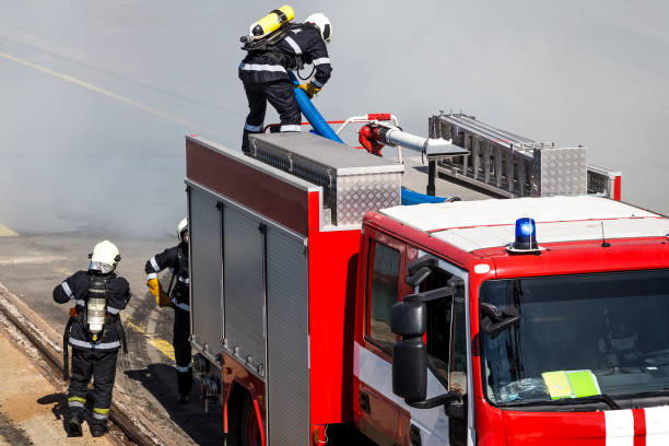 istock a team of three firefighters is preparing to quench a fire. 902203284