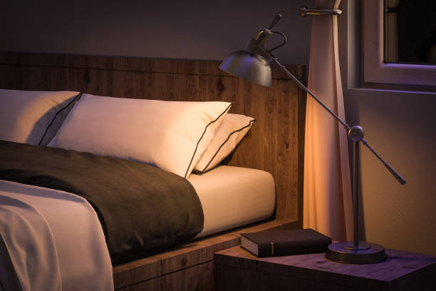 bedroom interior with book and reading lamp stock photo