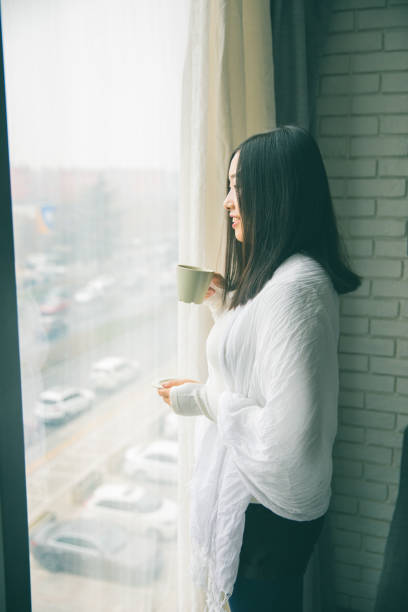 istock Looking out of window in thought 902210048