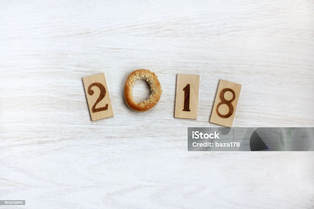 appetizing 2018 year flat layout of the wooden pieces with numbers and a top view of a bagel Abstract Stock Photo