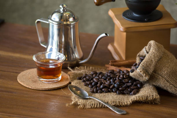 istock Vintage manual coffee grinder with coffee beans and cup 902212982
