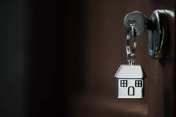 istock Silver house key in a door 902214222