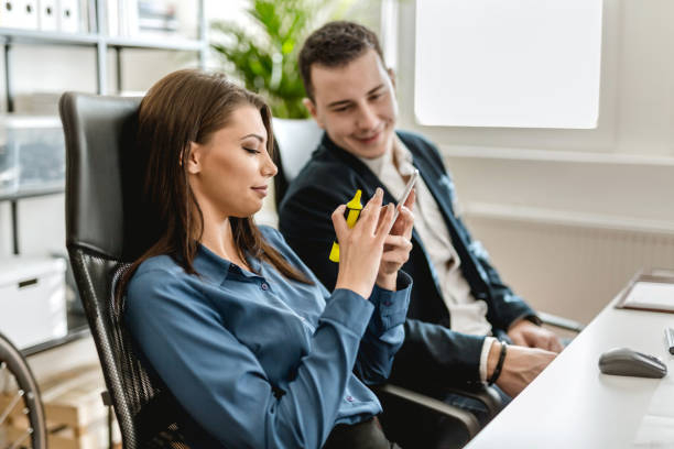 istock Young couple working in the office and using their smart phone 902214298