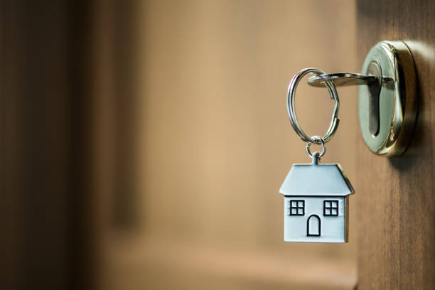 istock house key in a door 902214304