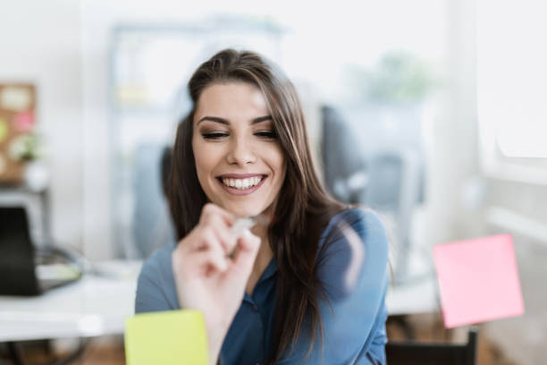 istock Young woman writing on a glass wipe board 902217152