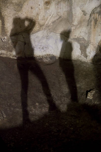 istock Shadow of a mother and son in a cave 902217172