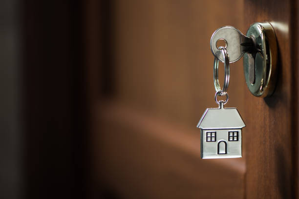 istock Silver house key in a door 902217192