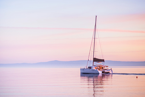Beautiful bay with sailing boat at sunset, Croatia