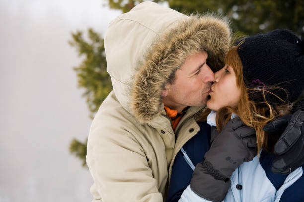 istock kissing couple in winter 902217970