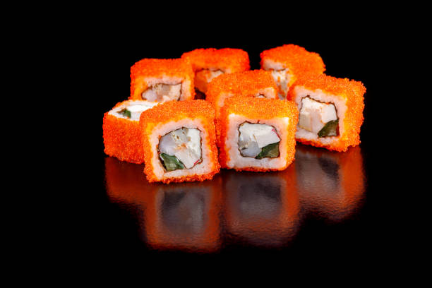 istock Fresh sushi rolls with an octopus and crab stick on a black background. 902217998
