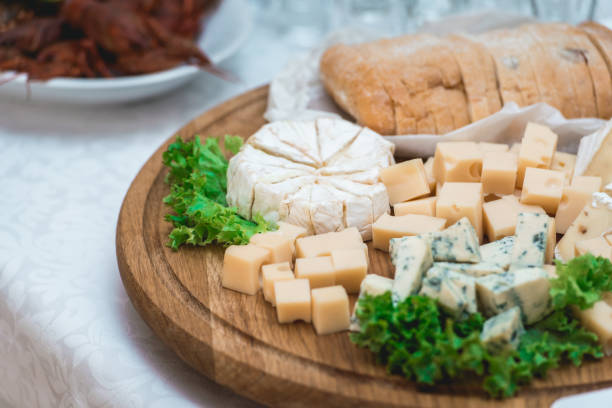 istock Mix cheese on wooden board with meat and bread 902218038