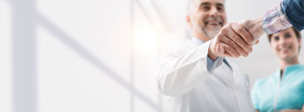 istock Doctor and patient shaking hands 902220870