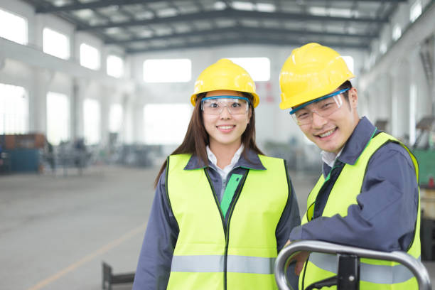 young chinese man and woman work in motor manufacturing factory