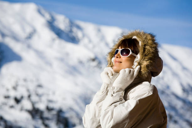 woman on a terrace in snowy mountains - skiing winter women snow imagens e fotografias de stock