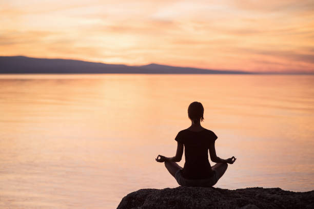 istock Woman is practicing yoga outdoors. Meditation and harmony concept 902228076