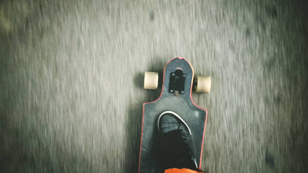 istock Longboarder driving on the street 902228428