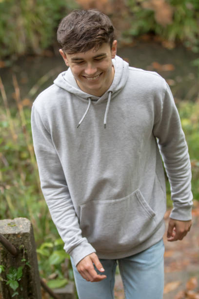 istock Teenage boy walking up steps outside 902238412