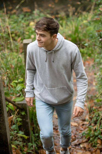 istock Teenage boy walking up steps outside 902240920