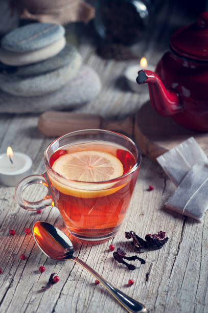 istock Glass with red tea on rustic wooden table 902247746