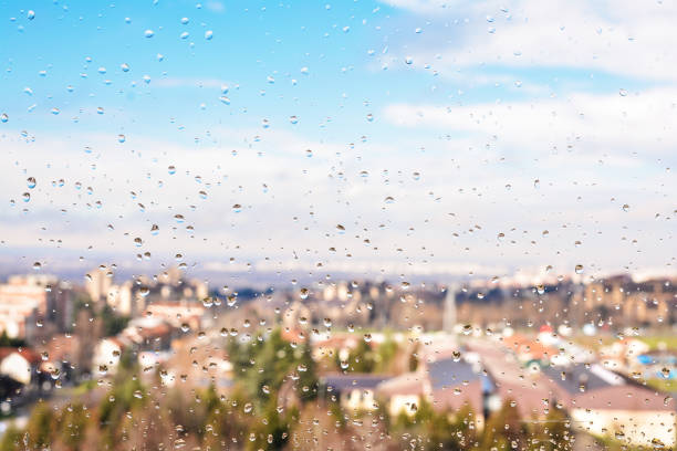 istock Rain drops and city roofs 902248506