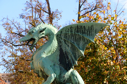 Ljubljana, Slovenia - October 30, 2017: Dragon sculpture on The Dragon Bridge in Ljubljana, Slovenia. The Dragon Bridge is a historical landmark in Ljubljana.