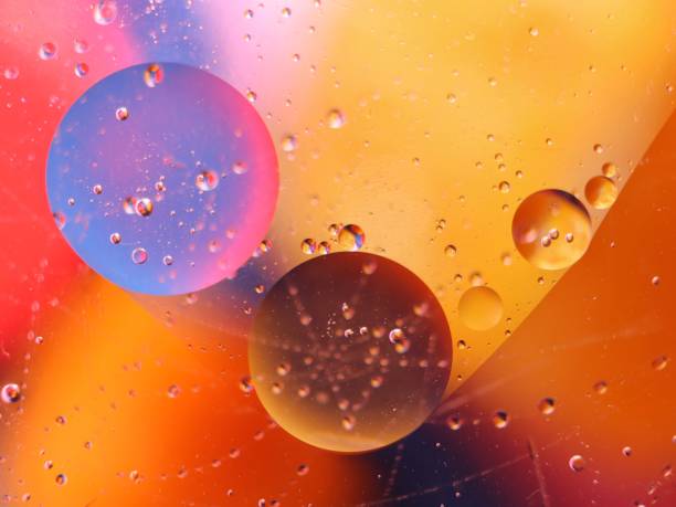 istock abstract colorful backdrop with oil drops on water surface. possible themes for the application - cosmetic advertising, space, fantasy 902251152