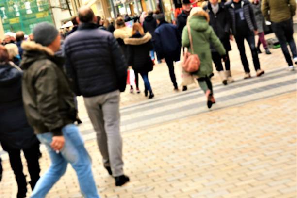 istock An concept Image of people walking in a shopping arcade - blurred 902258212