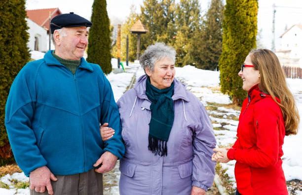 istock Elderly couple and young caregiver 902260500