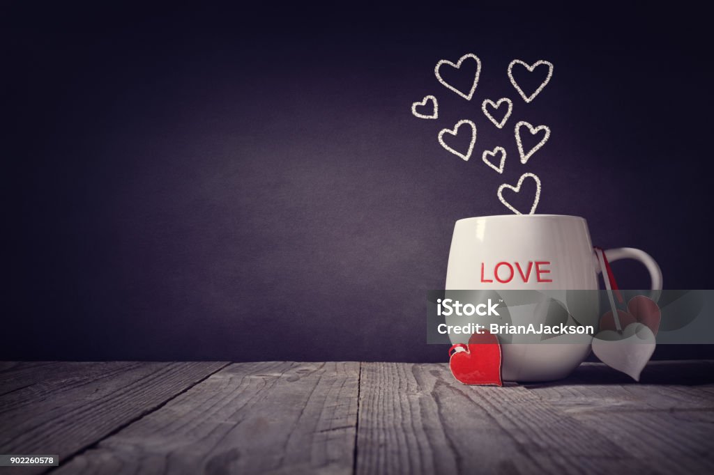 Love written on a mug concept for Valentines day or Mothers day background with copy space Love written on a mug with hearts concept for Valentines day or Mothers day background with copy space Coffee - Drink Stock Photo
