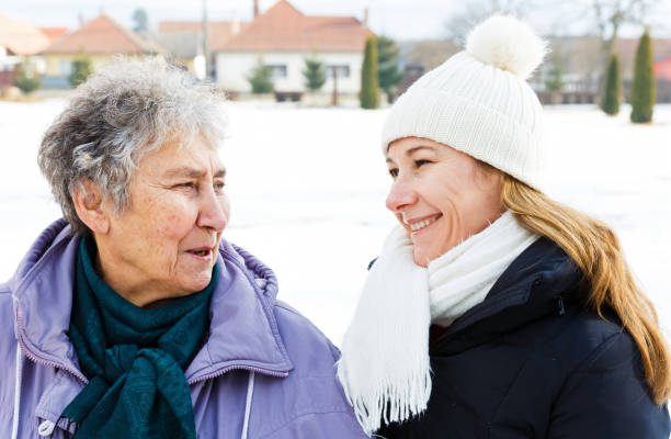 istock Smiling elderly woman and young caregiver 902260758