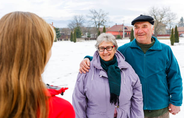istock Happy elderly couple and young caregiver 902261868