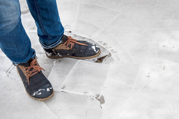 istock A man stands on ice in suede shoes 902267340