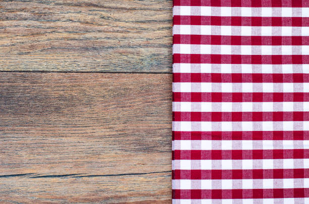 istock Tablecloth in white and red cage on wooden table 902269574