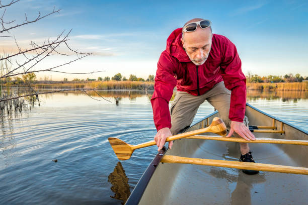 istock paddling canoe on calm lake 902272970