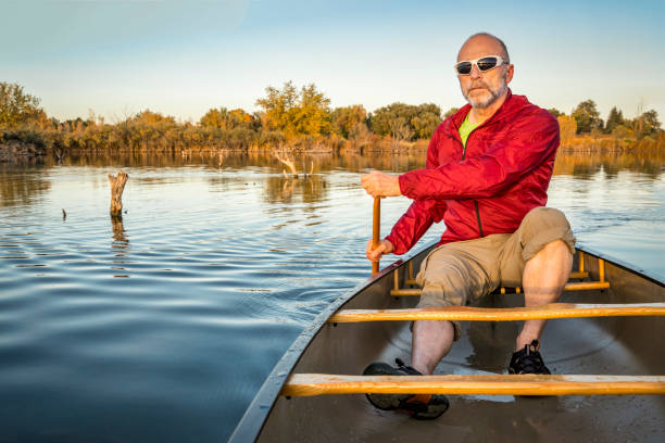 istock paddling canoe on calm lake 902275274