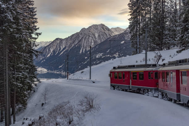istock Red train in the snow in swiss alps 902278116