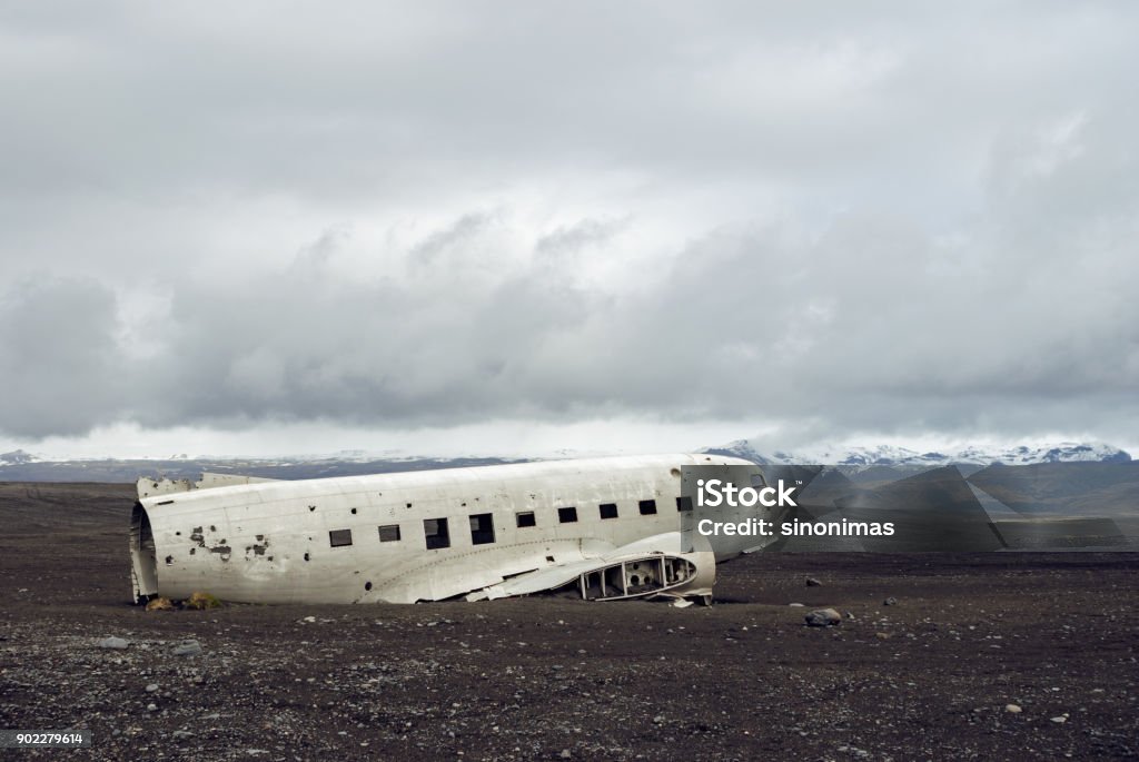 Crashed military plane in black sand Solheimasandur beach The US Navy DC-3 super bus airplane crash landed in Iceland. Solheimasandur beach, close to town Vik. Airplane Stock Photo